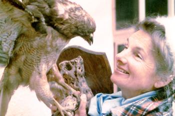 A woman look up at an eagle.