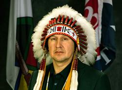 Chief Tony Alexis in a feather headdress.