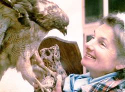 A woman look up at an eagle.